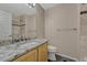 Bathroom featuring granite countertop and tiled shower with glass door at 12711 Colorado Blvd # 714G, Thornton, CO 80241