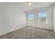 Bright bedroom with plush carpeting and abundant natural light from two windows at 12711 Colorado Blvd # 714G, Thornton, CO 80241