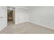 Bedroom with gray carpeting, showing an open door and closet at 12711 Colorado Blvd # 714G, Thornton, CO 80241