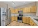 Modern kitchen with stainless steel appliances, granite countertops, and light wood cabinets at 12711 Colorado Blvd # 714G, Thornton, CO 80241