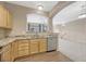Kitchen with granite counters, a stainless steel dishwasher, and natural wood cabinets at 12711 Colorado Blvd # 714G, Thornton, CO 80241