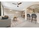 Bright living area featuring a comfortable couch, dining area, and barstool seating at 12711 Colorado Blvd # 714G, Thornton, CO 80241