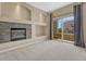 Living room featuring a stone fireplace and large sliding glass doors to balcony at 12711 Colorado Blvd # 714G, Thornton, CO 80241
