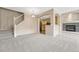 Open-concept living area with staircase, fireplace, and kitchen views at 12711 Colorado Blvd # 714G, Thornton, CO 80241