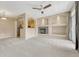 Open-concept living room with fireplace, recessed lighting, and kitchen view at 12711 Colorado Blvd # 714G, Thornton, CO 80241