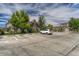Exterior view of parking spaces and community buildings amidst lush greenery at 12711 Colorado Blvd # 714G, Thornton, CO 80241