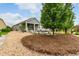 A nicely landscaped backyard with a stone patio and covered back porch at 7991 Heritage Dr, Thornton, CO 80602