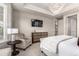 Bedroom featuring neutral walls, carpet floors, sitting area, and tray ceiling with a modern chandelier at 7991 Heritage Dr, Thornton, CO 80602