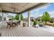 View of the backyard and patio from the covered back porch with outdoor seating and ceiling fan at 7991 Heritage Dr, Thornton, CO 80602