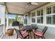 A covered back porch with outdoor table and chairs, ceiling fan, and backyard view at 7991 Heritage Dr, Thornton, CO 80602