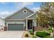 Attractive single-Gathering home with stone and siding exterior, complemented by a green lawn and professional landscaping at 7991 Heritage Dr, Thornton, CO 80602