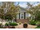 Well-manicured front yard with mature trees, decorative rock landscaping, and lush greenery, enhancing curb appeal at 7991 Heritage Dr, Thornton, CO 80602