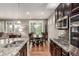 Modern kitchen with stainless steel appliances, granite countertops, and dark cabinets at 7991 Heritage Dr, Thornton, CO 80602