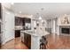 Open-concept kitchen with a large granite island, stainless steel appliances, and hardwood floors at 7991 Heritage Dr, Thornton, CO 80602