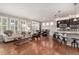 Bright, open-concept living area flows into kitchen and dining, with hardwood floors and plantation shutters at 7991 Heritage Dr, Thornton, CO 80602