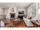 Cozy living room features a stone fireplace, large TV, and comfortable seating area at 7991 Heritage Dr, Thornton, CO 80602