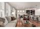 Open-concept living space with hardwood floors, great natural light, and a view of the kitchen at 7991 Heritage Dr, Thornton, CO 80602