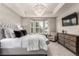 Luxurious main bedroom features a tray ceiling, bay window, and elegant chandelier at 7991 Heritage Dr, Thornton, CO 80602