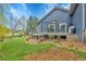 Spacious backyard featuring a lush lawn, mature trees, and an inviting deck with outdoor seating at 1 Red Fox Ln, Littleton, CO 80127