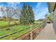 Serene backyard featuring a well-maintained lawn, mature trees, and a charming wooden fence at 1 Red Fox Ln, Littleton, CO 80127