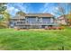 Expansive backyard showcasing a well-maintained lawn, multi-level decks, and mature landscaping at 1 Red Fox Ln, Littleton, CO 80127