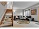 Comfortable basement with plush seating, stairway access, and natural lighting at 1 Red Fox Ln, Littleton, CO 80127