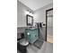 Charming bathroom features a blue vanity, sleek black fixtures, and stone tiled walls at 1 Red Fox Ln, Littleton, CO 80127