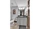 Bathroom featuring a gray vanity, granite countertop, framed mirror, and white subway tiled shower at 1 Red Fox Ln, Littleton, CO 80127