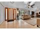 Well-lit foyer with hardwood floors, modern door, and a comfortable seating area at 1 Red Fox Ln, Littleton, CO 80127