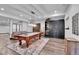 Game room features a pool table, modern lighting fixture, and seating area with decorative rug at 1 Red Fox Ln, Littleton, CO 80127