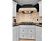 A gourmet kitchen features a cooktop and custom range hood above at 1 Red Fox Ln, Littleton, CO 80127