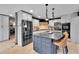 Modern kitchen featuring granite countertops, stainless steel appliances, and a breakfast bar at 1 Red Fox Ln, Littleton, CO 80127
