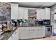Kitchen with white cabinets, granite counters, stainless appliances, and a wine fridge at 1 Red Fox Ln, Littleton, CO 80127