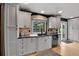 Modern kitchen features white cabinets, a black sink, and a window overlooking the yard at 1 Red Fox Ln, Littleton, CO 80127