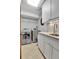 Bright laundry room features a modern washer and dryer, ample counter space, and storage cabinets at 1 Red Fox Ln, Littleton, CO 80127