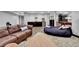 Living room featuring wood-look floors, a large couch, and a small bar area at 1 Red Fox Ln, Littleton, CO 80127