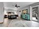 Spacious main bedroom with ceiling fan, outdoor access, and decorative accent furniture at 1 Red Fox Ln, Littleton, CO 80127