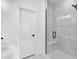 Modern bathroom with glass shower, white subway tile, a built-in bench and sleek hardware at 8028 W 52Nd Ln # B, Arvada, CO 80002