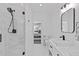 Bright bathroom featuring glass shower with black hardware, a sink and a view to the bedroom at 8028 W 52Nd Ln # B, Arvada, CO 80002