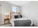 Serene bedroom featuring neutral tones, a woven headboard, and a soft, textured throw blanket at 8028 W 52Nd Ln # B, Arvada, CO 80002