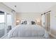Bright bedroom with en-suite bathroom and sliding glass door leading to private balcony at 8028 W 52Nd Ln # B, Arvada, CO 80002
