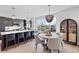 Bright modern kitchen features a large island, pendant lighting, quartz counters, and stainless steel appliances at 8028 W 52Nd Ln # B, Arvada, CO 80002
