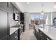 Modern kitchen boasts stainless steel appliances, a farmhouse sink, and a large window at 8028 W 52Nd Ln # B, Arvada, CO 80002