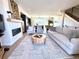 Spacious living room featuring hardwood floors, a modern fireplace, and an open floor plan into the kitchen at 8028 W 52Nd Ln # B, Arvada, CO 80002
