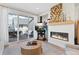 Cozy living room with modern fireplace, mantel, and sliding glass doors to a covered patio at 8028 W 52Nd Ln # B, Arvada, CO 80002