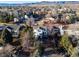 Aerial view of the property showcasing the home, surrounding neighborhood, and mountain views in the distance at 8369 W Fairview Ave, Littleton, CO 80128