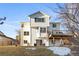 The backyard shows a two-story home with a deck and a well-maintained lawn, ready for outdoor enjoyment at 8369 W Fairview Ave, Littleton, CO 80128