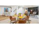 Open-concept basement features a dining area, bar, and living space with a modern fireplace at 8369 W Fairview Ave, Littleton, CO 80128