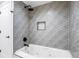 Modern bathroom featuring geometric tile, a tub and shower combo with matte black hardware at 8369 W Fairview Ave, Littleton, CO 80128