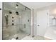 A modern bathroom with a glass enclosed shower, double shower heads, and a built-in bench at 8369 W Fairview Ave, Littleton, CO 80128
